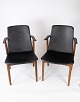 This pair of 
armchairs in 
classic black 
leather and 
teak, designed 
by Hans Olsen 
from the 1960s, 
...