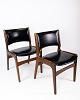 A set of chairs 
in teak and 
with black 
leather, 
designed by 
Erik Buch in 
the 1960s, 
exudes a ...