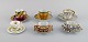 Limoges, Frankrig og Royal Doulton, England. Seks mokka / dekorationskopper i 
håndmalet porcelæn med blomster og gulddekoration. 1900-tallet.
