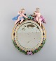 Antique Meissen porcelain mirror with original glass. Decorated with angels and 
repousse flowers. 19th century.
