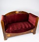 Two seater sofa of walnut with inlaid wood and upholstered with red velvet from around 1910. The ...