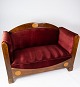 Two seater sofa 
of walnut with 
inlaid wood and 
upholstered 
with red velvet 
from around 
1910. The ...