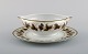 Limoges sauce boat on stand in porcelain with hand-painted grape vines and gold 
decoration. 1930s / 40s.
