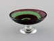 Göran Wärff (b.1933) for Kosta Boda. Bowl / compote in mouth-blown art glass. 
Spiral design in shades of red and green. 1980s.

