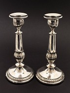 A pair of empire silver candlesticks