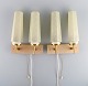 Scandinavian 
designer. A 
pair of double 
brass wall 
lamps with 
glass shades. 
Mid-20th ...