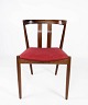 Spisestuestol i teak og polstret med rødt stof af dansk design fra 1960erne. 
5000m2 udstilling.