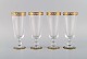 Nason & Moretti, Murano. Four champagne flutes in mouth-blown art glass with 
hand-painted turquoise and gold decoration. 1930s.

