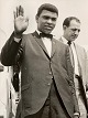 The 24-year-old 
world 
heavyweight 
champion 
Muhammad Ali 
(Cassius Clay) 
is waving on 
arrival at ...