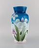 Antik vase i mundblæst opalineglas med håndmalede blomster og bladværk på blå 
baggrund. Ca. 1900.  
