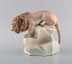 Amphora, Czechoslovakia. Hand-painted art deco porcelain figurine of lion on 
rock. 1930s / 40s.
