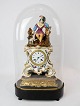 French table 
clock with 
glass dome and 
decorated with 
figure of 
porcelain from 
1860. The clock 
...