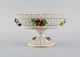 Dresden compote in openwork porcelain with hand-painted flowers and gold 
decoration. 1920s.
