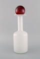 Otto Brauer for 
Holmegaard. 
Vase / bottle 
in white art 
glass with red 
ball. 1960s.
Measures: ...