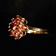 A gold ring set 
with granates, 
mounted in 14k 
gold. 
Ring size 55. 
Granates diam. 
12 mm. ...