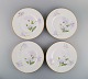 Four antique unique Royal Copenhagen plates in porcelain with hand-painted 
purple lotus flowers. Model number 72/10520. Approx. 1910.
