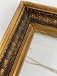 Old wooden gold 
frame with 
leaves and 
glass. The 
frame is from 
the beginning 
of the 20th ...