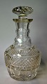 Crystal carafe with stopper, 19th century. With numerous grindings. H .: 25 cm.