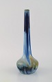 Gentil Sourdet, France. Long necked vase in glazed stoneware. Beautiful glaze in 
shades of blue and green. Mid-20th century.
