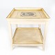 Antique side table of white painted wood and decorated with print.
5000m2 showroom.