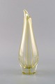 Bengt Orup 
(1916-1996) for 
Johansfors. 
Strict vase in 
clear 
mouth-blown art 
glass with 
yellow ...