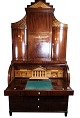 Large Empire 
bureau of 
polished 
mahogany  with 
inlaid wood and 
decorated with 
carvings, from 
the ...