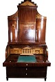 Large Empire bureau of polished mahogany  with inlaid wood and decorated with 
carvings, from the 1840s. 
5000m2 showroom.