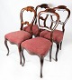 Set of four dining room chair of mahogany and upholstered with red fabric from the 1860s. The ...