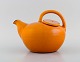 Brack & Sønner, Denmark. Teapot in glazed stoneware. Beautiful glaze in orange 
shades. Mid-20th century.
