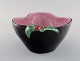 French studio ceramicist. Bowl in glazed ceramics modeled with flowers. Pink 
interior glaze. Late 20th century.
