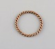 Scandinavian jeweler. Braided ring in 8 carat gold. Mid-20th century.
