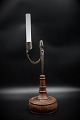 Swedish 1800 century candlestick in wrought iron and wooden base with fine patina. Height: 32cm.
