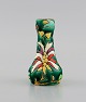 Longwy, France. Art deco vase in glazed stoneware with hand-painted flowers on a 
green background. 1920s / 30s.
