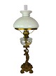 Kerosene lamp of patinated metal and shade of white opaline glass from around 1860. The lamp is ...