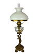 Kerosene lamp 
of patinated 
metal and shade 
of white 
opaline glass 
from around 
1860. The lamp 
is ...