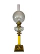 Kerosene lamp of brass with white opaline glass shade and yellow glass stem, from around the ...