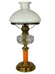 Kerosene lamp of brass with white opaline glass shade and orange glass stem, from around the ...