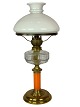 Kerosene lamp 
of brass with 
white opaline 
glass shade and 
orange glass 
stem, from 
around the ...