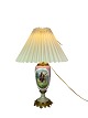 Table lamp of porcelain with motif and bronze from around the 1920s. The lamp is with a paper ...