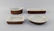 Stig Lindberg for Gustavsberg. Bowl and three dishes in glazed stoneware. 
Beautiful speckled glaze in brown shades. Swedish design, 1960s.
