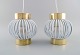 Two designer 
pendants in 
brass and white 
plastic. 1960s 
/ 70s.
Measures: 18 x 
18 cm.
In ...