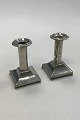 A Pair of hammered candlelight holders made of Pewter. With skews at the top. Square base.  ...