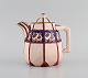 Longwy, France. Art deco teapot in glazed stoneware with hand-painted flower 
decoration. 1920s / 30s.
