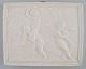Bing and Grøndahl after Thorvaldsen. Antique biscuit wall plaque with putis and swan in relief. ...