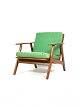 Easy chair in teak and with green upholstery of Danish design from the 1960s. The chair can be ...