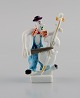 Peter Strang (b.1936) for Meissen. Figure in hand-painted porcelain. Double 
bassist from the clown orchestra. Late 20th century.
