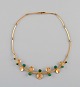 Just Andersen, Denmark. Necklace in 18 carat gold adorned with nine cone-shaped 
malachites. 1930s / 40s.
