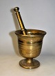 Brass mortar 
with pistil, 
19th century. 
Denmark. On a 
round foot. 
With 
decorations on 
the side. ...