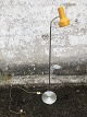 Floor lamp with yellow shade. Height approx. 130 cm. Some dents on the foot.