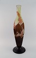 Colossal antique Emile Gallé "Ricin" vase in frosted art glass with light brown 
and delicate pink carvings in the form of flowers and foliage. Rare model. Early 
20th century.
